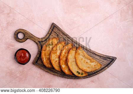 Fried Burekas With Filling On A Light Stone Background. Top View. Selective Focus.
