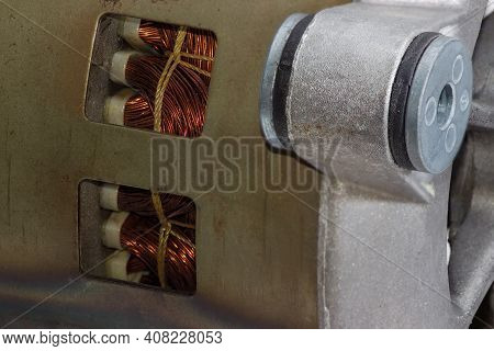 Fragment Of Electric Motor With Ventilation Holes In The Housing, Through Which Can Be Seen Windings