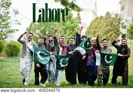 Lahore City. Group Of Pakistani Man Wearing Traditional Clothes With National Flags. Biggest Cities