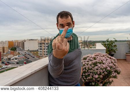 Bearded Man In A Gray And Green Sweater With A Mask To Protect Himself From The Coronavirus By Makin