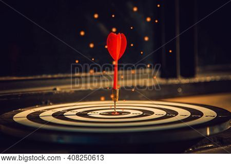 Dart Arrow Hit On Bulleyes Of Dartboard To Represent That The Business Reached The Target  With Dark