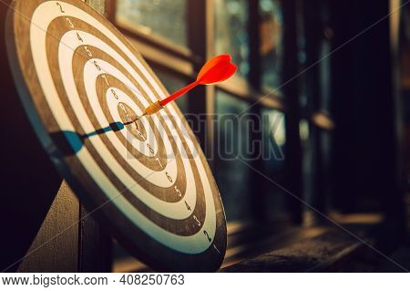 Dart Arrow Hit On Bulleyes Of Dartboard To Represent That The Business Reached The Target  With Dark