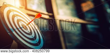 Dart Arrow Hit On Bulleyes Of Dartboard To Represent That The Business Reached The Target  With Dark