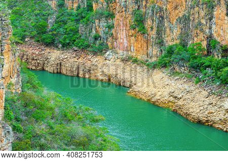 Lake With Natural Green Water Surrounded By Sedimentary Rocks On Lake Shore And Green Vegetation. Ph