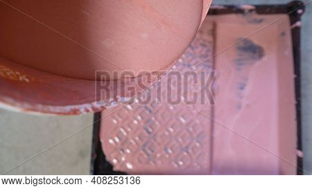 The Plasterer Pours The Primer From The Canister. Worker Pours The Primer Into The Paint Tray. Prepa