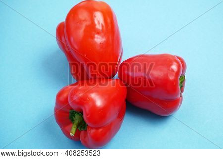 Red Sweet Peppers On Blue Background, Bellpeppers, Paprika, Closeup