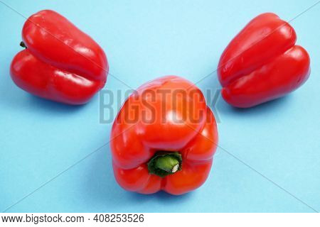 Red Sweet Peppers On Blue Background, Bellpeppers, Paprika, Closeup