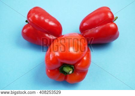 Red Sweet Peppers On Blue Background, Bellpeppers, Paprika, Closeup