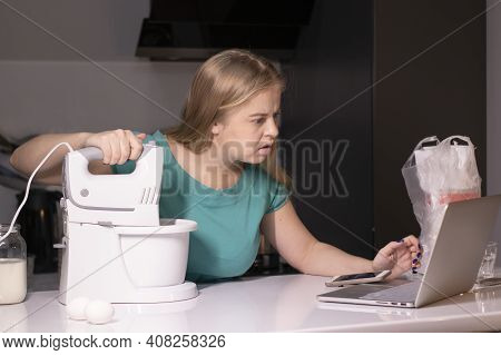 A Blonde Woman Chef Videoblogger Cooking In The Kitchen And Filming, Online Learning Or Remote Cooki