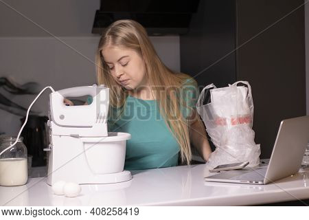 A Blonde Woman Chef Videoblogger Cooking In The Kitchen And Filming, Online Learning Or Remote Cooki