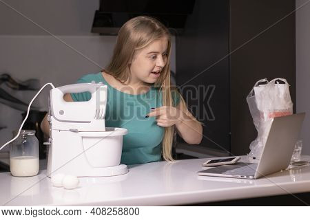 A Blonde Woman Chef Videoblogger Cooking In The Kitchen And Filming, Online Learning Or Remote Cooki