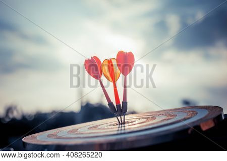 Close Up Shot Of The Dart Arrow Hit On Bulleyes Of Dartboard To Represent That The Business Reached