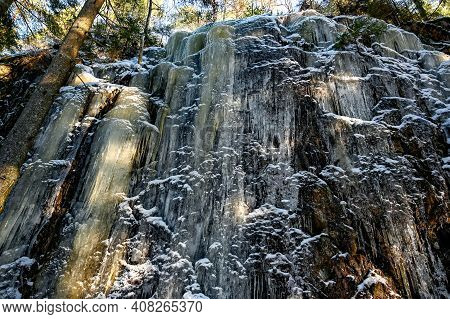 Mountain Side Covered In Ice In Forest Narke Sweden