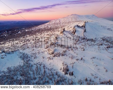 Colorful Winter Sunset In Sheregesh Ski Resort Mountains With Clouds. Aerial Top View Forest Russia
