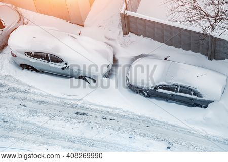 Top Aerial View Of Apartment Office Building Parking Lot With Many Cars Covered By Snow Stucked Afte