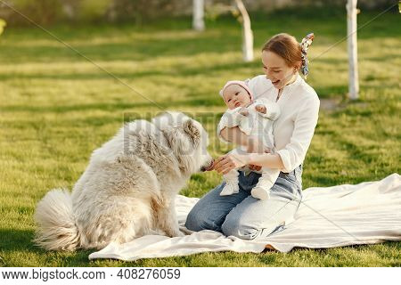 Family Spend Time In A Summer Garden