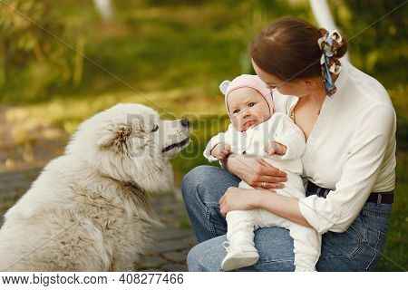 Family Spend Time In A Summer Garden