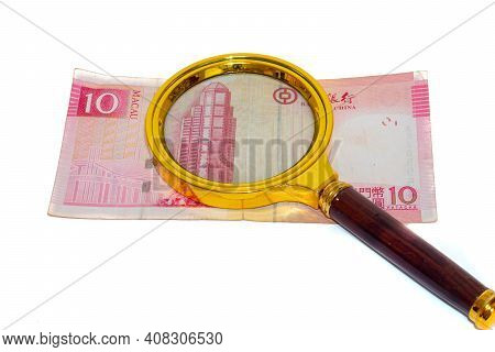 10 Macau Money Paper Patacas Under A Magnifying Glass Isolated On White Background Front Side