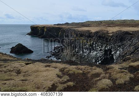Basalt Columns Along The Rock Cliffs On The Coast Of Iceland.