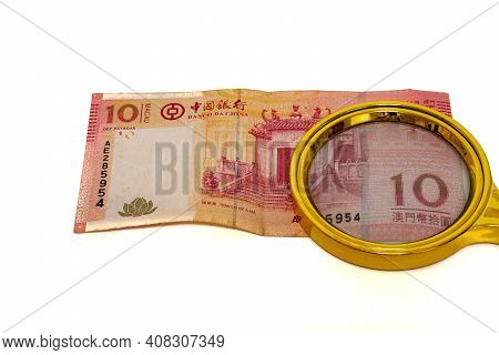 10 Macau Patacas Money Paper Under A Magnifying Glass Isolated On White Background Back Side