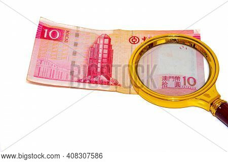 10 Macau Patacas Money Paper Under A Magnifying Glass Isolated On White Background Front Side