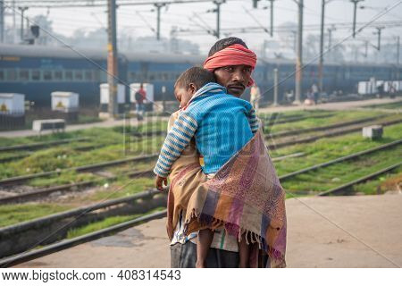 Varanasi. India. 05-10-2018. Father Is Taking Care Of His Sleeping Son At Varanasi Train Station.