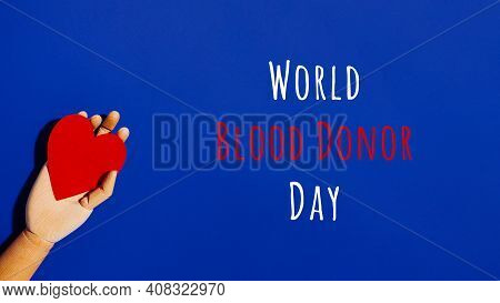 Wooden Hand With Big Red Heart In A Giving Gesture. World Blood Donor Day Wording. Donation, Help, H