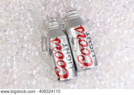 IRVINE, CALIFORNIA - APRIL 15, 22019: Coors Light Aluminum Pint Bottles surrounded by ice cubes.