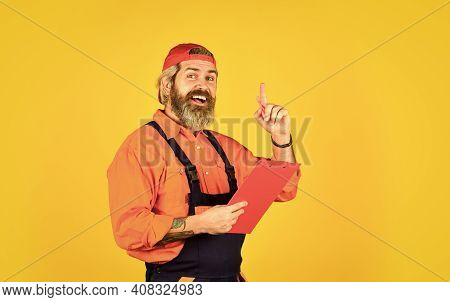 Delivery Man In Cap Holding Clipboard Looking Information. Check List. Control Concept. Courier With
