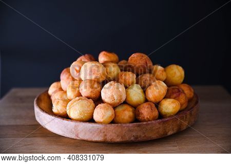 Baked Castagnole On Wooden Background. Street Food, Round Biscuits With Sugar For The Carnival Of Ve