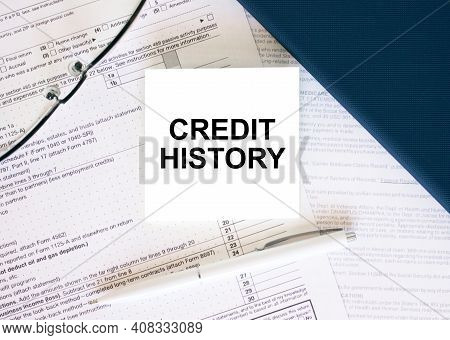 Tax Form With Business Card With Text Credit History. Notepad, Eyeglasses And White Pen
