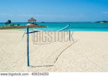 Net for beach volleyball standing on a sandy beach on a sunny day