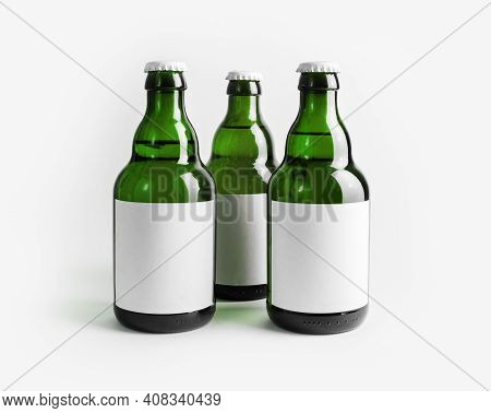 Three Green Beer Bottles With Blank Labels.