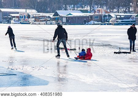 Prague, Czech Republic - February 14, 2021. Family Ice Skating On Frozen River Moldau - Vltava In Cr