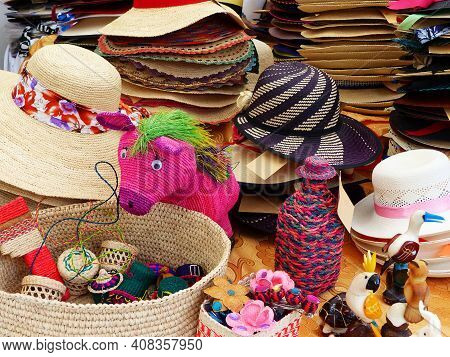 Colorful Handmade Souvenirs From Straw - Panama Hats Or Paja Toquilla Hats Or Sombrero, Baskets And 