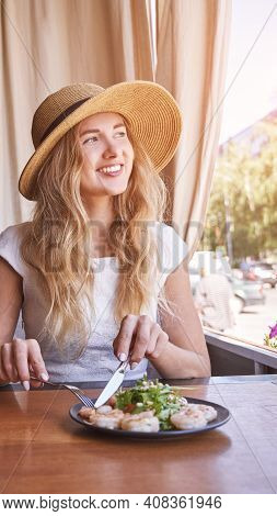 Young Woman At Restaurant Eating Shrimp Salad. Health Food Concept. Fork And Knife. Ountdoor Cafe. H