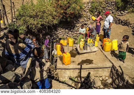 Lalibela, Ethiopia - Feb 14, 2020: People Getting Water At A Water Point In Lalibela, Ethiopia. Afri