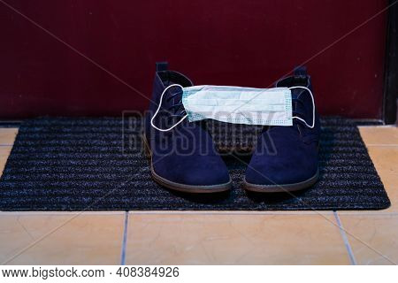 Pair Of Mens Blue Suede Semi-brogue Boots Covered With Facial Medical Mask As  Protection Symbol.