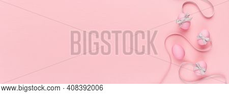 Cute And Naivety Easter Banner With Pink Eggs And Wavy Grey Ribbons On Pastel Pink Backdrop.