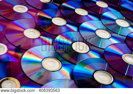 Background Cd And Dvd Discs Laid Out On A Flat Surface. Background For Saving Information. Abstracti