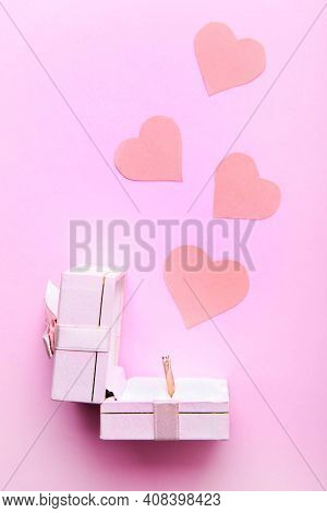 Engagement Ring From The Combined Gold With Diamond In Gift Box On Pink Background.