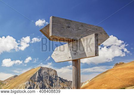 Wooden board sign for different directions on a mountain