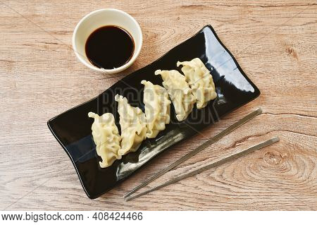 Steamed Gyoza Or Japanese Dumpling Stuffed Minced Pork Dipping Shoyu Sauce On Plate
