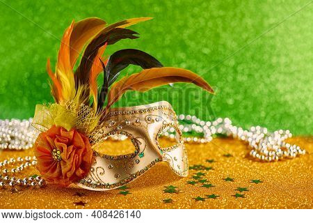 Festive, Colorful Mardi Gras Or Carnivale Mask With Feathers And Beads On Golden Background. Venetia