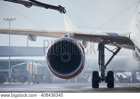 Deicing Of Aircraft Wing Before Flight. Winter Frosty Day At Airport.