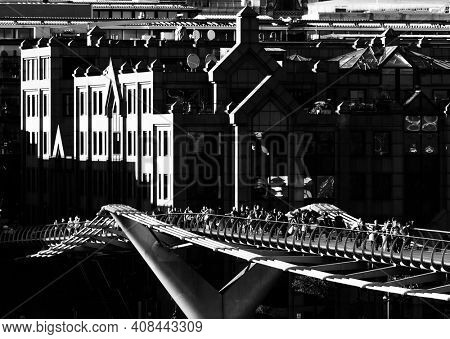 LONDON, UK - CIRCA JUNE 2011: Black and white shot of the Millennium Bridge. The Millennium Bridge is a steel suspension bridge over the Thames River for pedestrians.