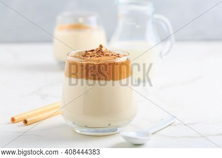 Dalgona coffee. Iced fluffy creamy whipped trend drink with coffee foam and milk.