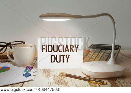 Office Desk With A Lamp That Illuminates The Inscription Fiduciary Duty