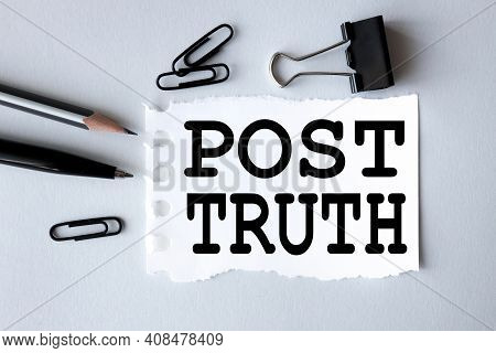 Post-truth. Text On White Paper On Gray Background