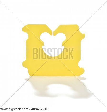 Close-up image of a plastic bread bag clip to hold plastic bags closed for sliced bread isolated on white background.  